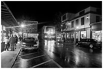 Street at night with people standing on sidewalk. Bar Harbor, Maine, USA (black and white)
