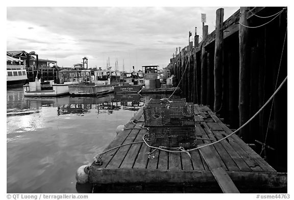 Lobster traps and fishing boats below pier. Portland, Maine, USA