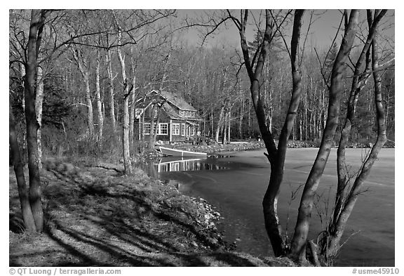 Lake, forest, and house in late winter. Maine, USA (black and white)