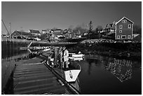 Men preparing to leave on small boat. Stonington, Maine, USA ( black and white)