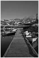 Deck, small boats, and houses. Stonington, Maine, USA (black and white)