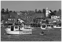 Lobsterman paddling towards boat. Corea, Maine, USA ( black and white)