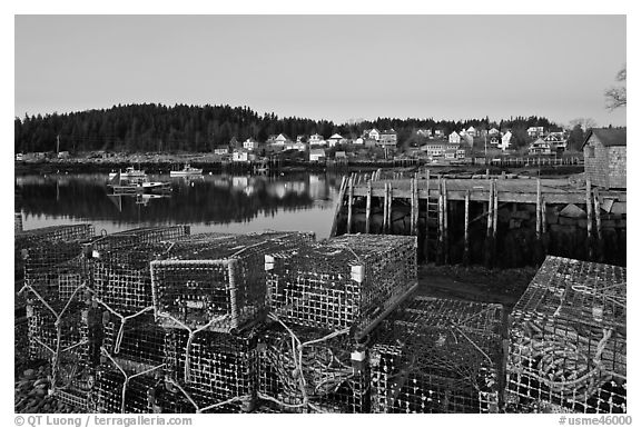 Lobster traps, pier, and village at dawn. Stonington, Maine, USA (black and white)