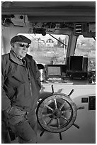 Captain of Isle-au-Haut mailboat aboard boat. Isle Au Haut, Maine, USA (black and white)