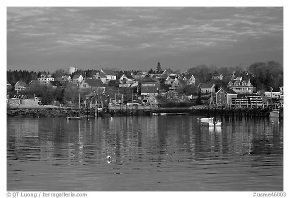 Harber and hillside houses at sunrise. Stonington, Maine, USA (black and white)