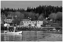 Men on small boat in harbor. Stonington, Maine, USA (black and white)