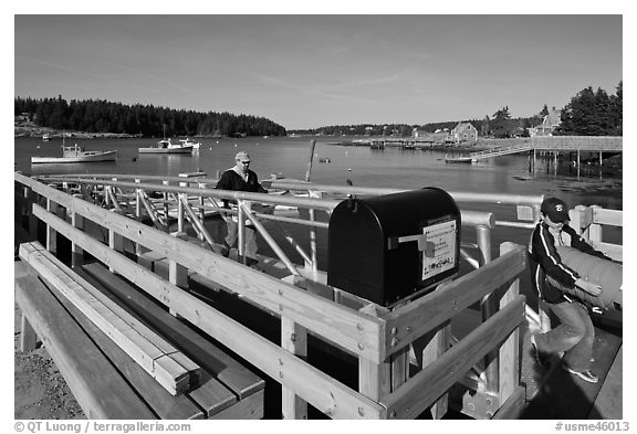Mailbox and people unloading mailboat. Isle Au Haut, Maine, USA (black and white)