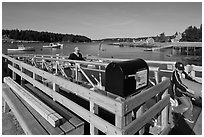 Mailbox and people unloading mailboat. Isle Au Haut, Maine, USA (black and white)