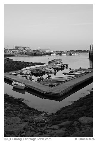 Small boats and harbor at sunset. Stonington, Maine, USA (black and white)