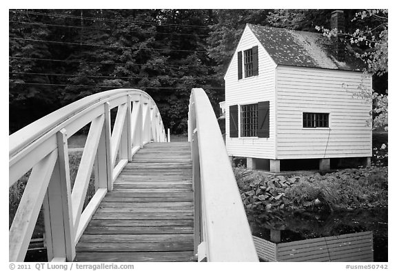 Wooden arched footbridge and house. Maine, USA (black and white)