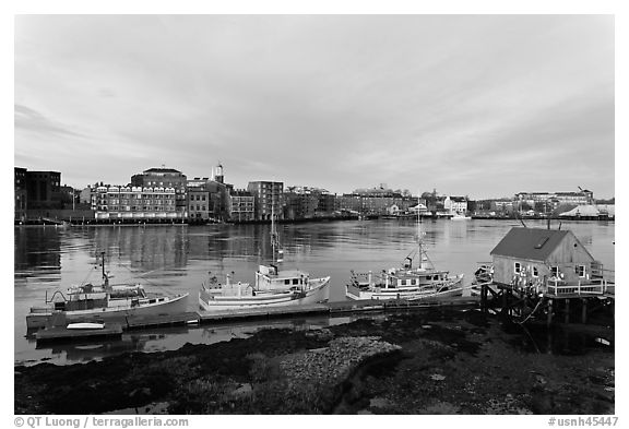 Boats, river, and skyline, early morning. Portsmouth, New Hampshire, USA (black and white)