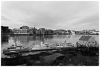 Boats, river, and skyline, early morning. Portsmouth, New Hampshire, USA (black and white)