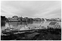 Boats, river, and skyline, early morning. Portsmouth, New Hampshire, USA (black and white)