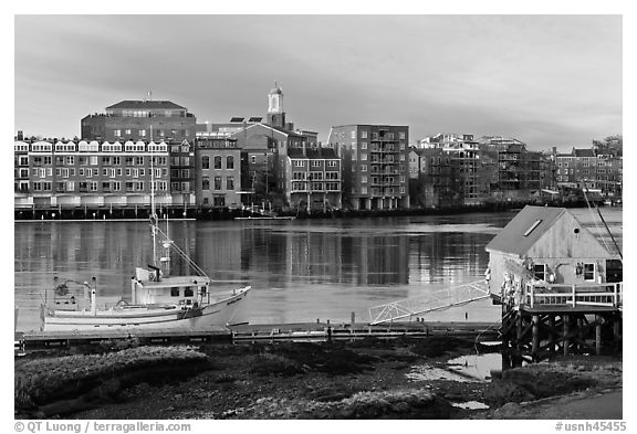 Fishing boat, shack, and waterfront buildings. Portsmouth, New Hampshire, USA (black and white)