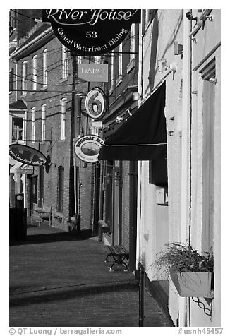 Sidewalk and waterfront buildings. Portsmouth, New Hampshire, USA (black and white)