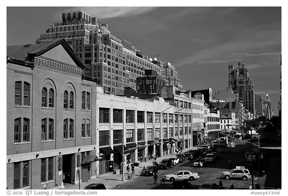 Taxi cars in streets and brick buildings. NYC, New York, USA (black and white)