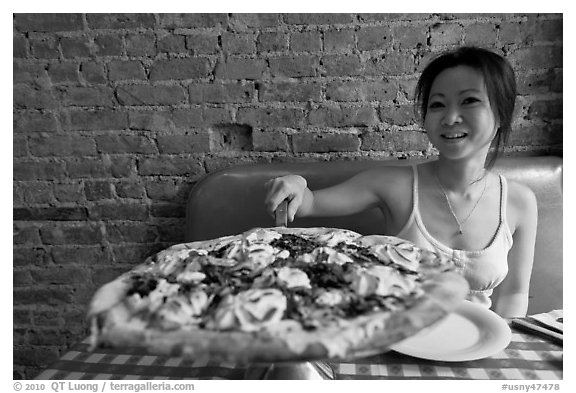 Woman getting slice of pizza at Lombardi. NYC, New York, USA