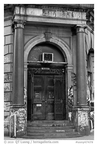 Door of old building on Bowery. NYC, New York, USA (black and white)