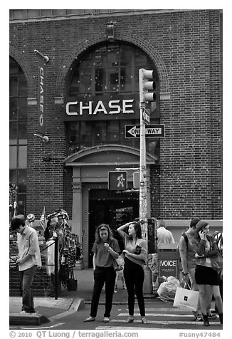 People waiting at crosswalk amidst bubbles. NYC, New York, USA (black and white)