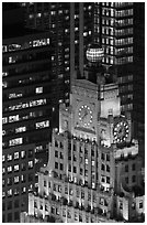 Top of vintage high-rise building with globe and clocks. NYC, New York, USA (black and white)