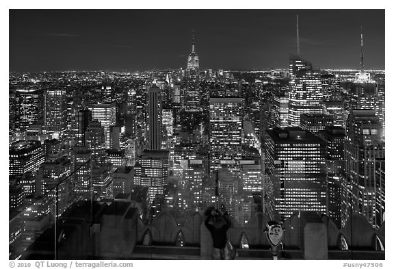 Woman on observation platform of Rockefeller center at night. NYC, New York, USA (black and white)