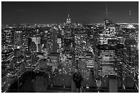 Woman on observation platform of Rockefeller center at night. NYC, New York, USA (black and white)