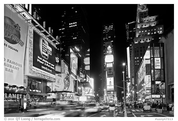 Taxis in motion, neon lights, Times Squares at night. NYC, New York, USA (black and white)