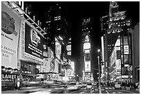 Taxis in motion, neon lights, Times Squares at night. NYC, New York, USA (black and white)