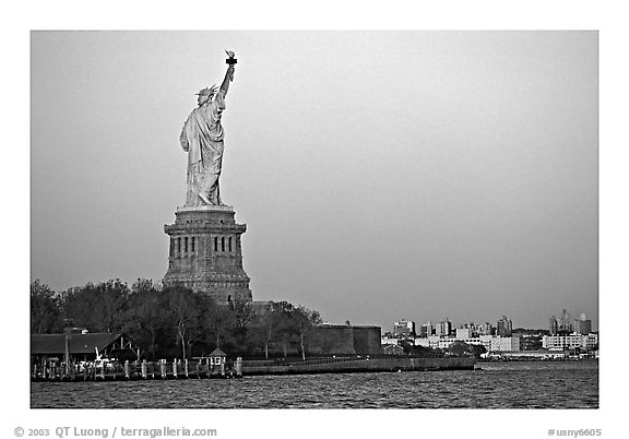 Statue of Liberty and Liberty Island from the back, sunset. NYC, New York, USA (black and white)