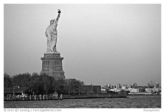 Statue of Liberty and Liberty Island from the back, sunset. NYC, New York, USA