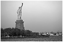 Statue of Liberty and Liberty Island from the back, sunset. NYC, New York, USA ( black and white)