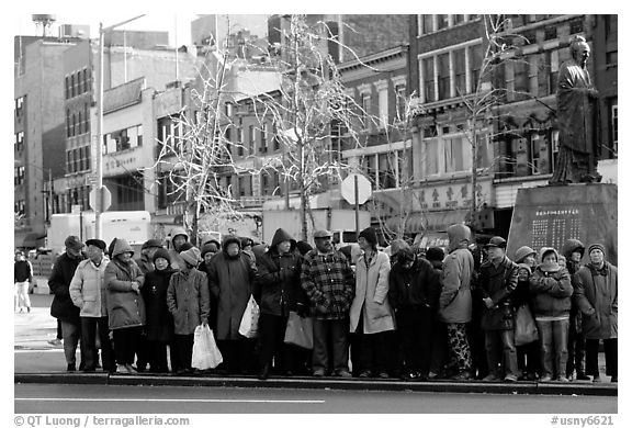 Gathering in Chinatown in winter. NYC, New York, USA (black and white)