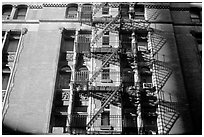 Emergency exit staircases on the side of a building. NYC, New York, USA ( black and white)