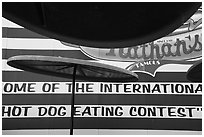 Sun umbrellas and hot dog eating contest wall. New York, USA ( black and white)