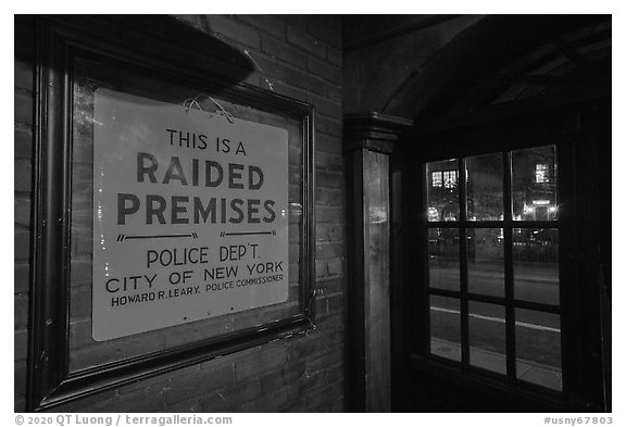 Raided Premises sign in Stonewall Inn, Stonewall National Monument. NYC, New York, USA (black and white)