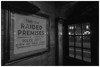 Raided Premises sign in Stonewall Inn, Stonewall National Monument. NYC, New York, USA ( black and white)
