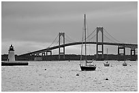 Newport Bridge and Newport Harbor lighthouse at sunset. Newport, Rhode Island, USA (black and white)