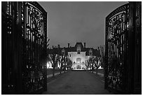 Entrance gate and historic mansion building at night. Newport, Rhode Island, USA ( black and white)