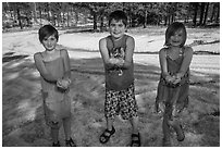 Children in summer dress holding large hailstones, Black Hills National Forest. Black Hills, South Dakota, USA (black and white)