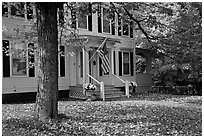 House with American flag and red leaves. Vermont, New England, USA (black and white)