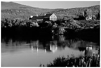 Red barns reflected in Line Pond near Pomfret. Vermont, New England, USA (black and white)