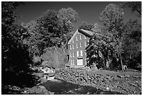 Old Mill next to a cascading brook near Stowe. Vermont, New England, USA ( black and white)