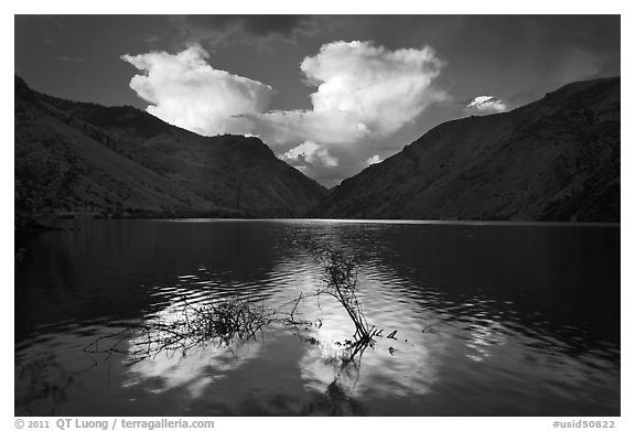 Thunderstorm clouds at sunrise reflected in reservoir. Hells Canyon National Recreation Area, Idaho and Oregon, USA (black and white)