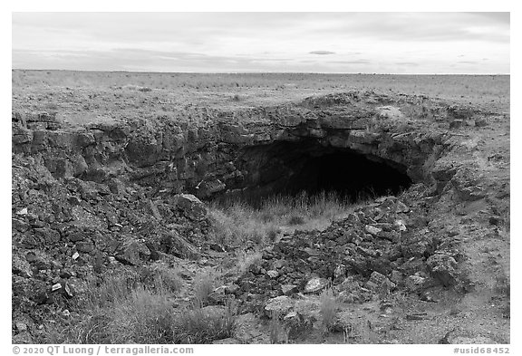 Plain with Bear Trap Cave entrance. Craters of the Moon National Monument and Preserve, Idaho, USA (black and white)