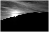 Sun at the rim of a cinder cone, sunrise, Craters of the Moon National Monument. Idaho, USA (black and white)