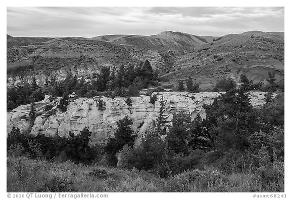 Sandstone pinnacles and hill with last light. Upper Missouri River Breaks National Monument, Montana, USA