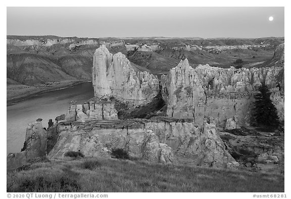 Sandstone spires and moon at twilight. Upper Missouri River Breaks National Monument, Montana, USA