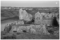 Sandstone spires and moon at twilight. Upper Missouri River Breaks National Monument, Montana, USA ( black and white)
