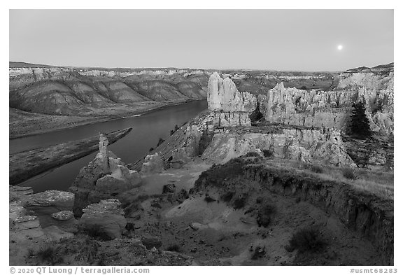 Rock columns and moon from Hole-in-the-Wall at dusk. Upper Missouri River Breaks National Monument, Montana, USA (black and white)