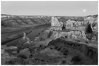 Rock columns and moon from Hole-in-the-Wall at dusk. Upper Missouri River Breaks National Monument, Montana, USA ( black and white)